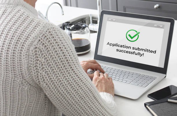 Man submitting an application online.