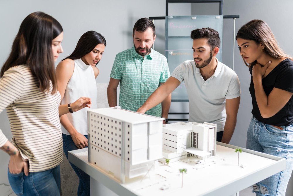 Hispanic architectural team planning over new project in office 