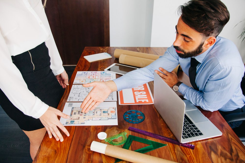 Real estate businessman reaching out hand 