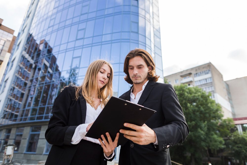Man and woman looking at a clipboard 