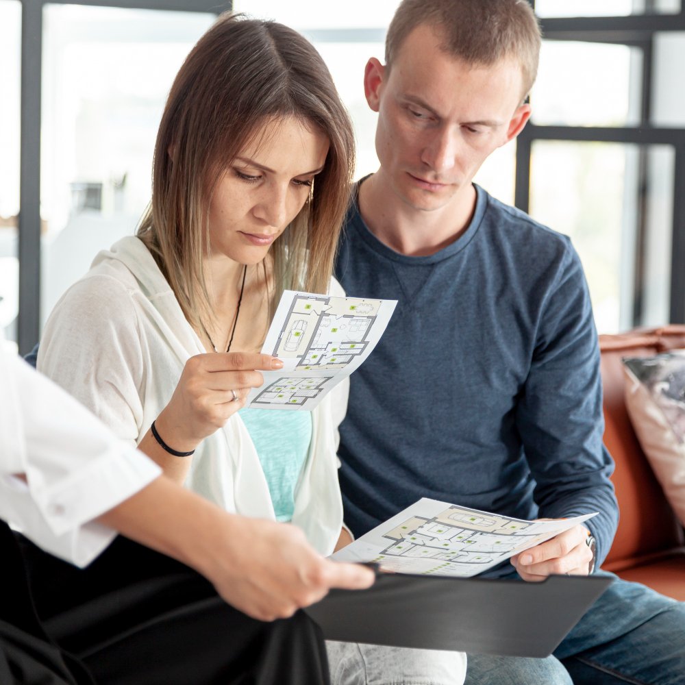 Couple looking together on house offers 