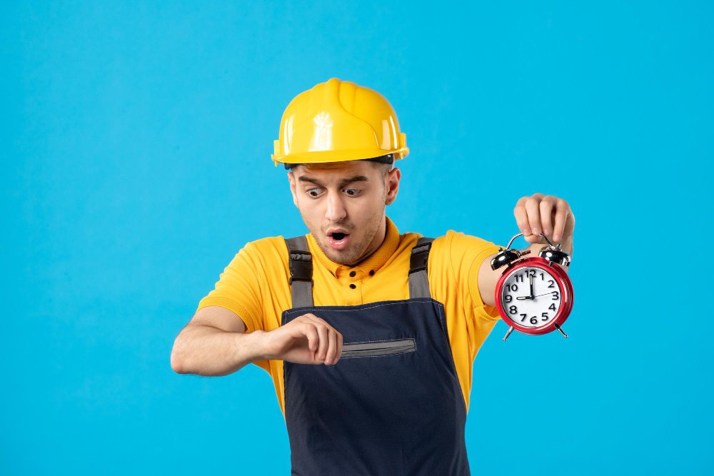 Front view of male worker in uniform with clocks being late on the blue 