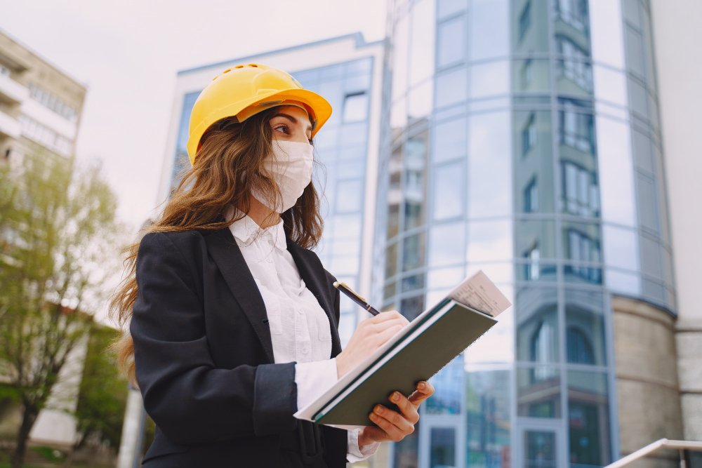 Female architect with construction site on the 