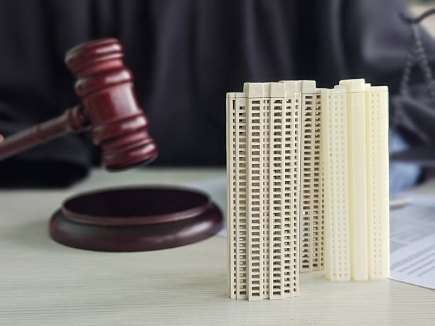 Model buildings beside a gavel representing legal decisions about real estate and urban development