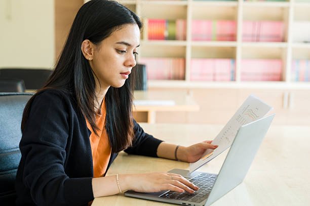 Professional asian businesswoman working in meeting room, office worker using laptop in conference room, business presentation report analysis, financial report reading, document checklist review.